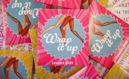 PInk condom wallets with "wrap it up" text